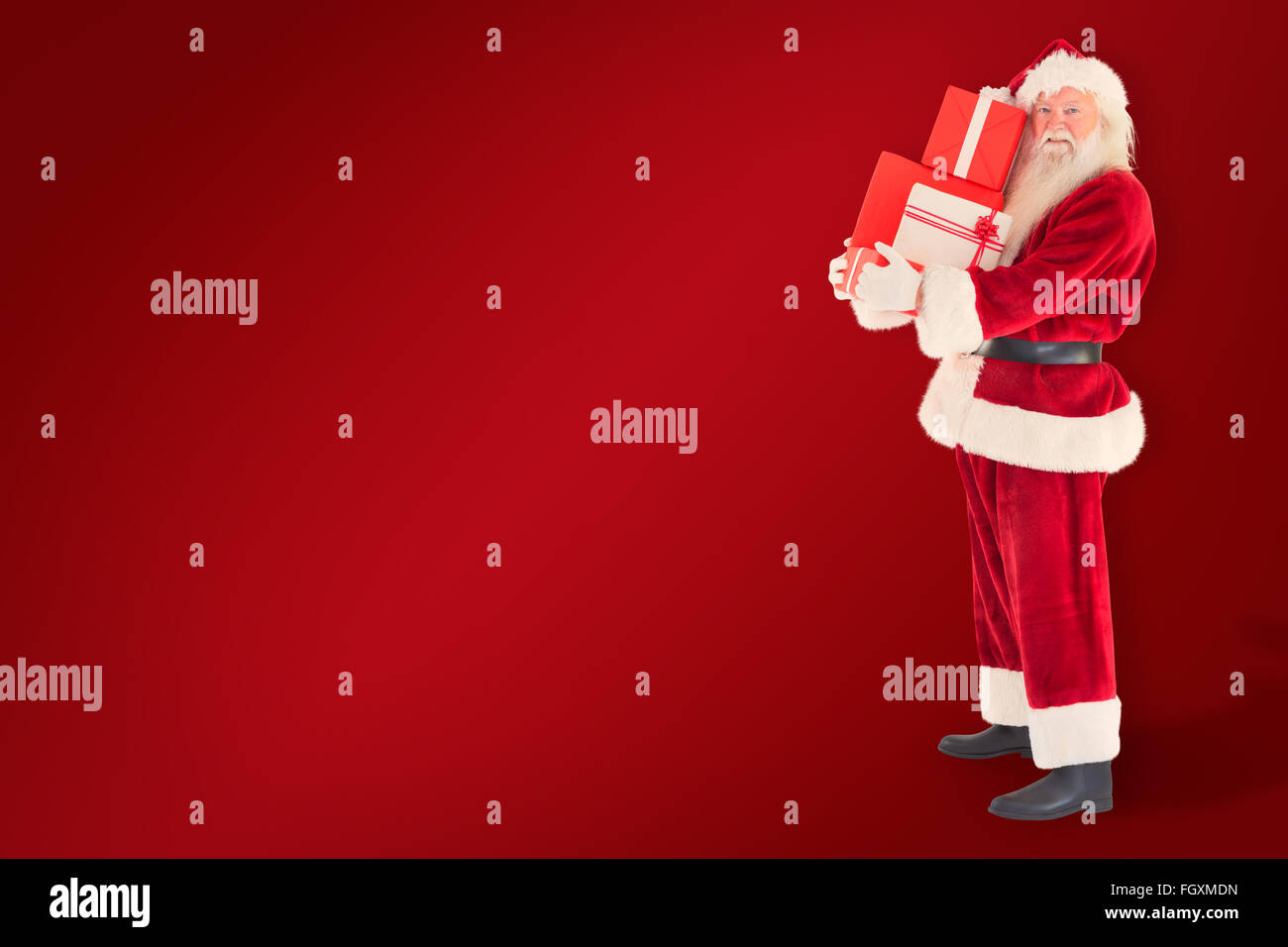Composite image of santa carries a few presents Stock Photo - Alamy