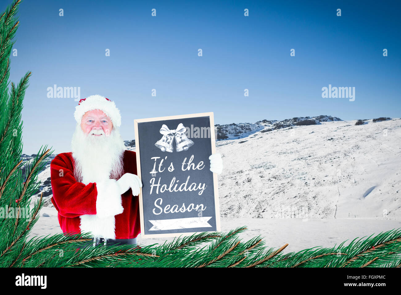 Composite image of santa claus showing blackboard Stock Photo - Alamy