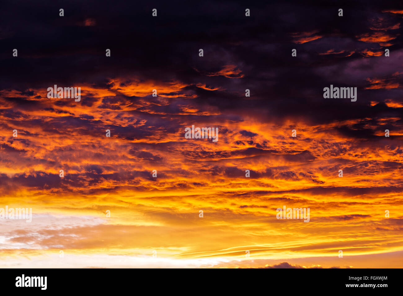 Golden fiery cloudy sunset sky Stock Photo