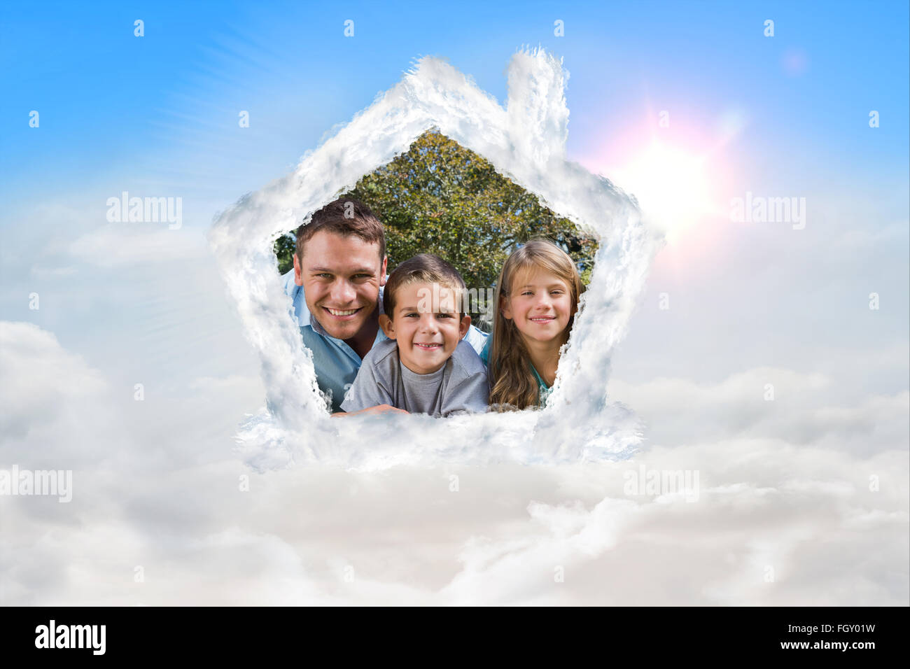 Composite image of happy family lying on the grass Stock Photo - Alamy