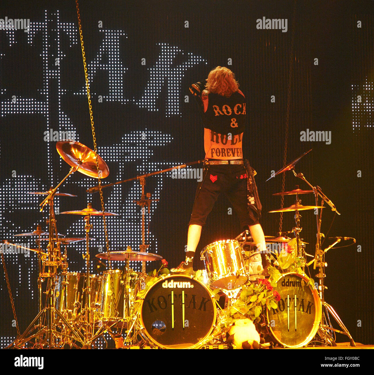 DNIPROPETROVSK, UKRAINE - OCTOBER 31, 2012: Drummer James Kottak takes off his t-shirt on the stage during 'Sting Tour 2012' Stock Photo