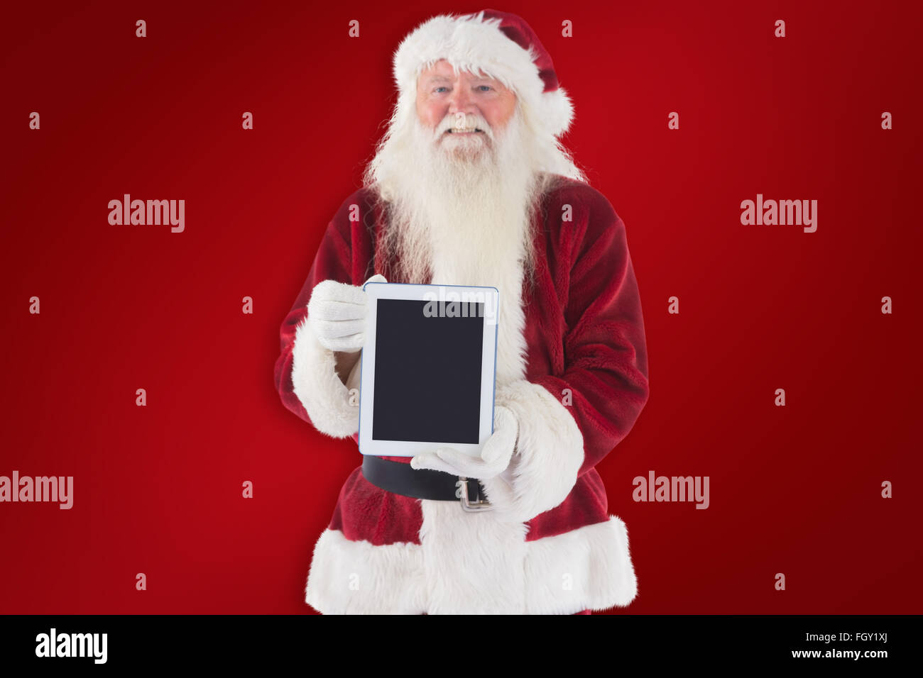 Composite image of santa presents a tablet pc Stock Photo - Alamy