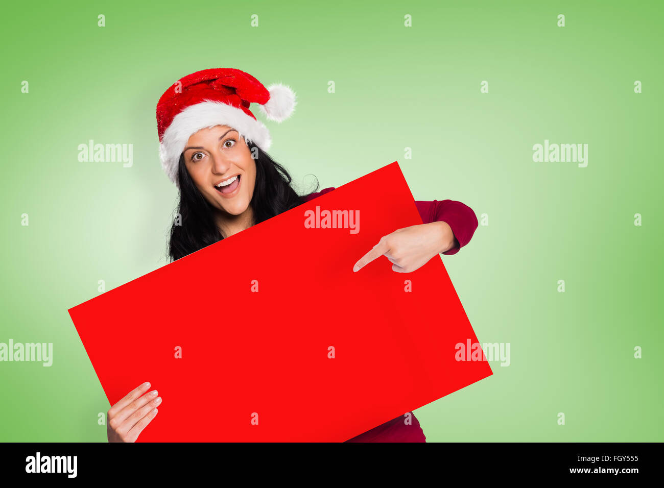 Composite image of woman pointing at sign Stock Photo - Alamy