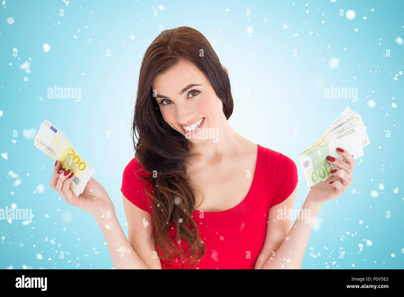 Composite image of cheerful brunette holding her cash money Stock Photo ...