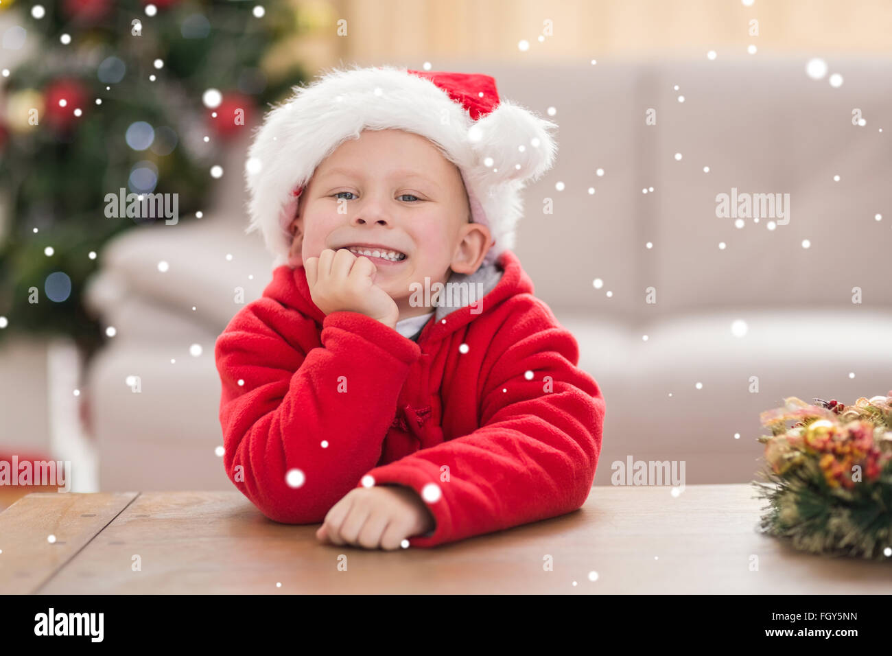 Composite image of festive little boy smiling at camera Stock Photo - Alamy