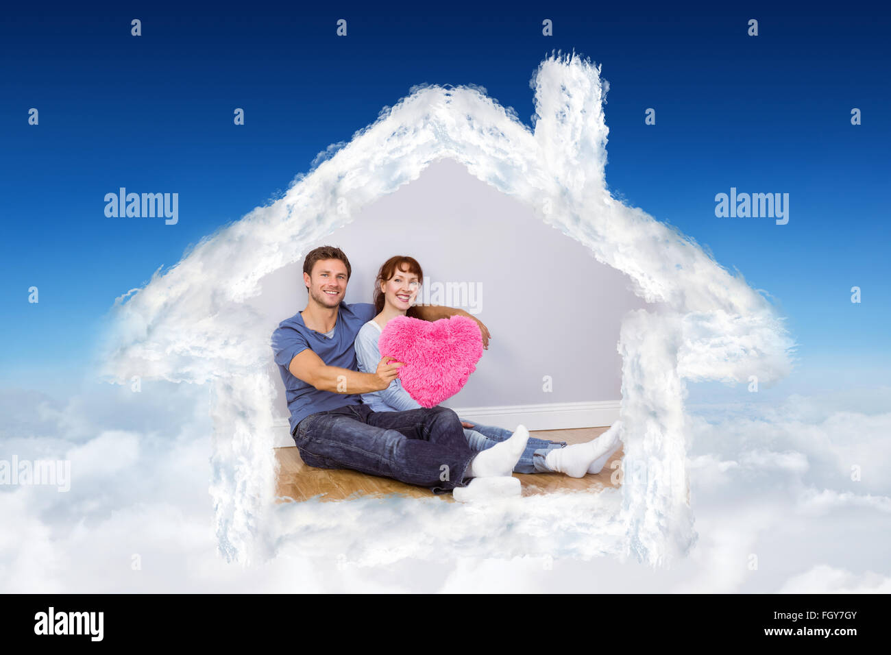 Composite image of couple holding a large heart Stock Photo