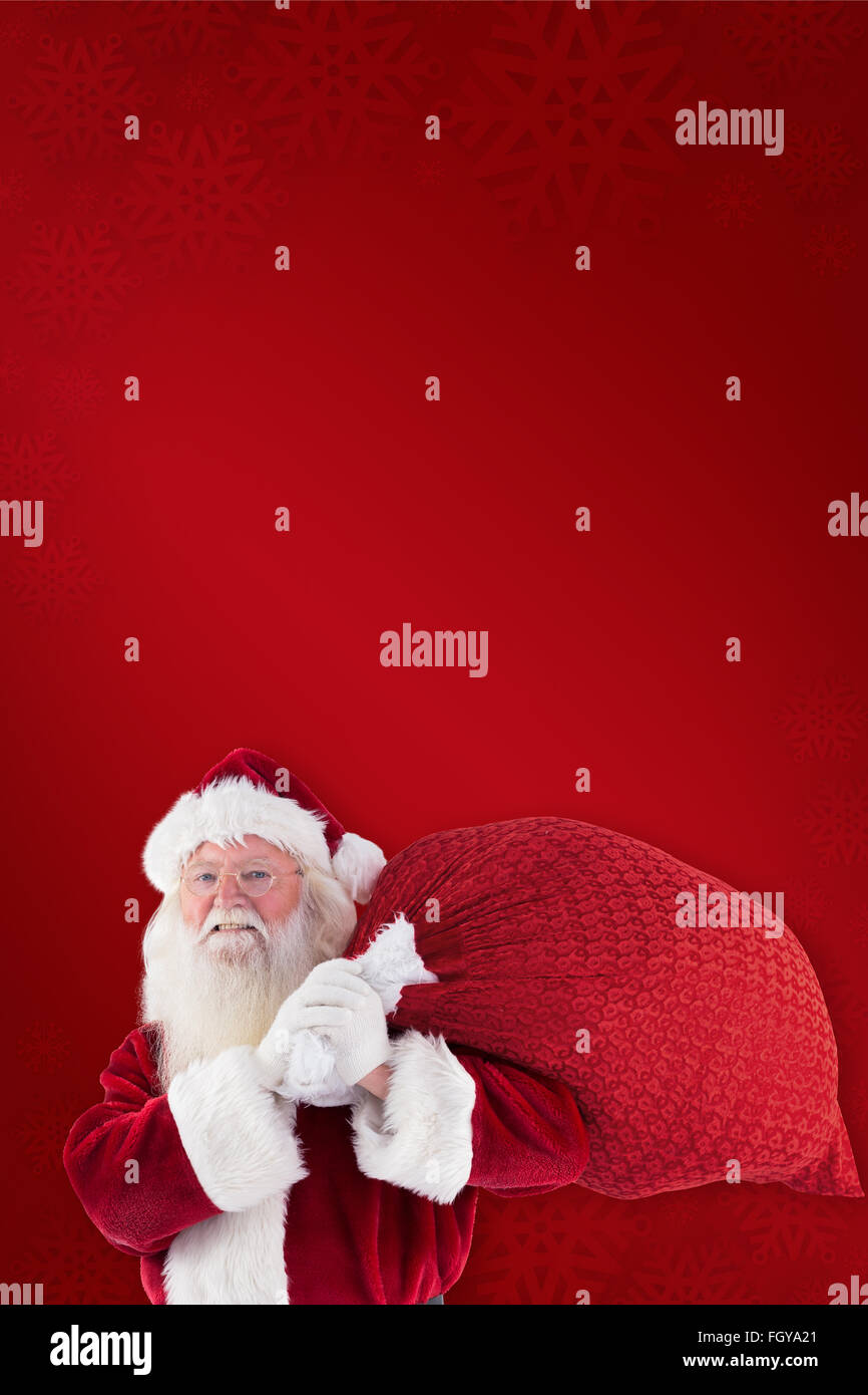 Composite image of santa claus carrying sack Stock Photo - Alamy