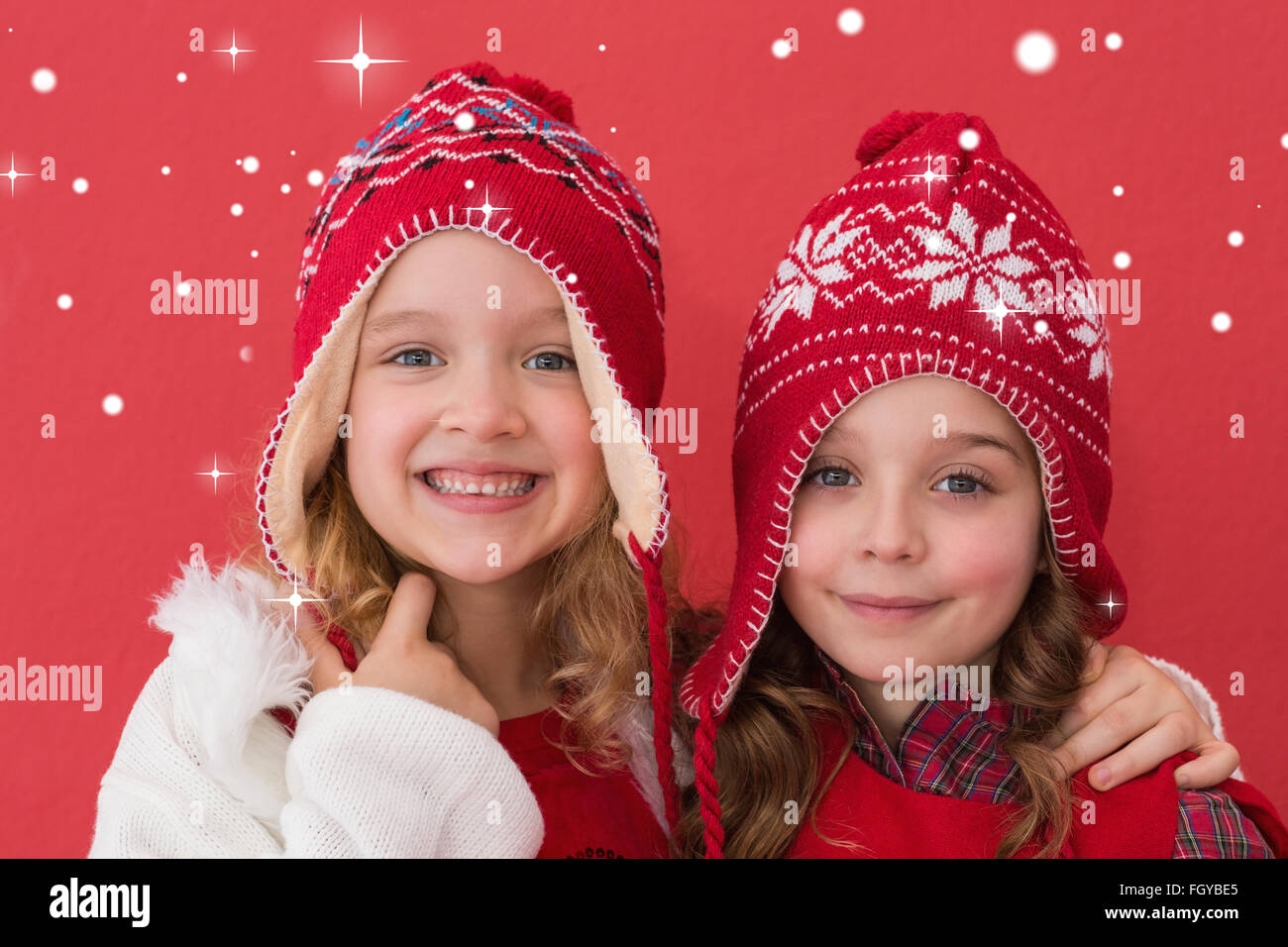 Composite image of festive little girls smiling at camera Stock Photo ...