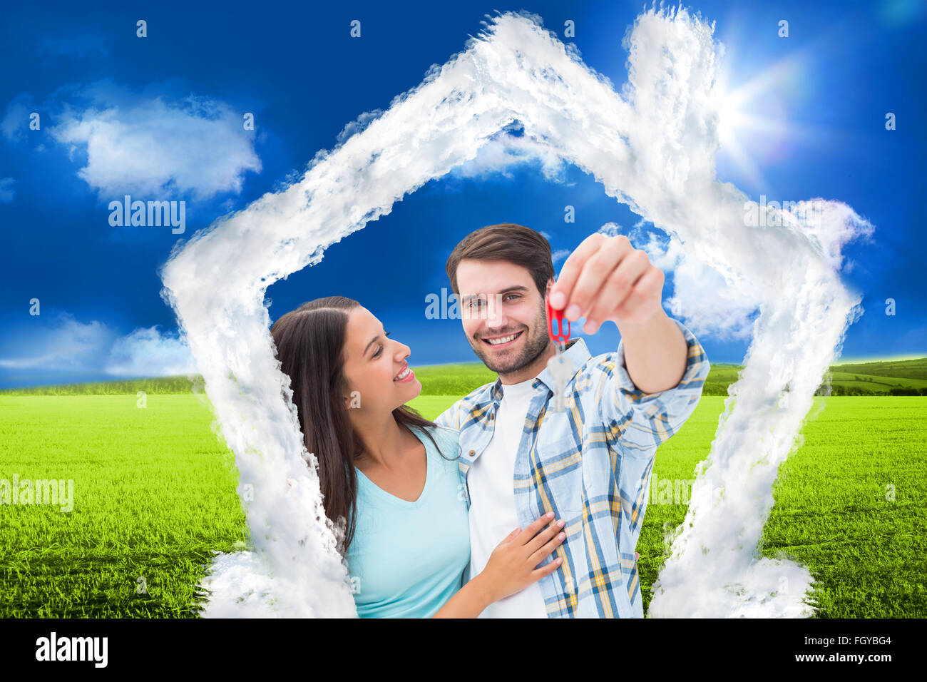 Composite image of happy young couple showing new house key Stock Photo ...