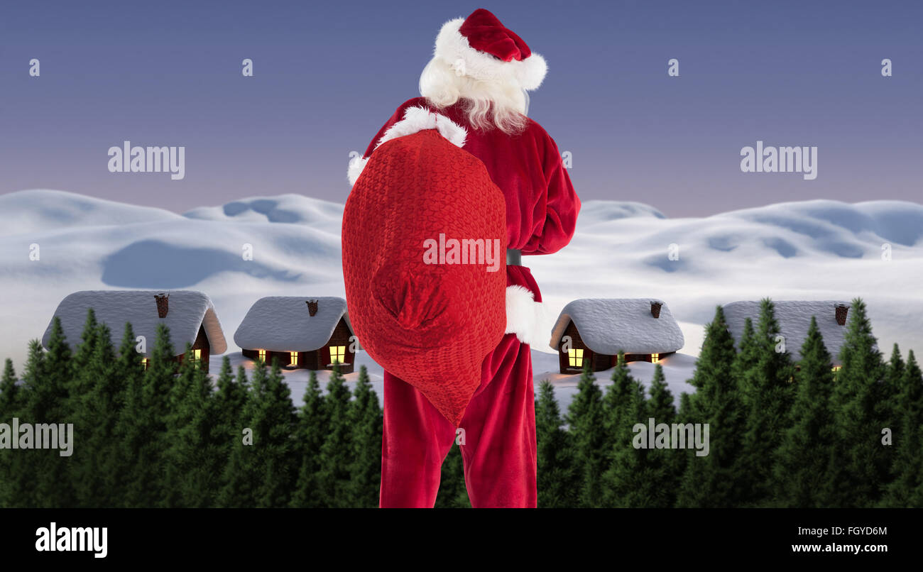 Composite image of santa is holding his bag in one hand Stock Photo - Alamy