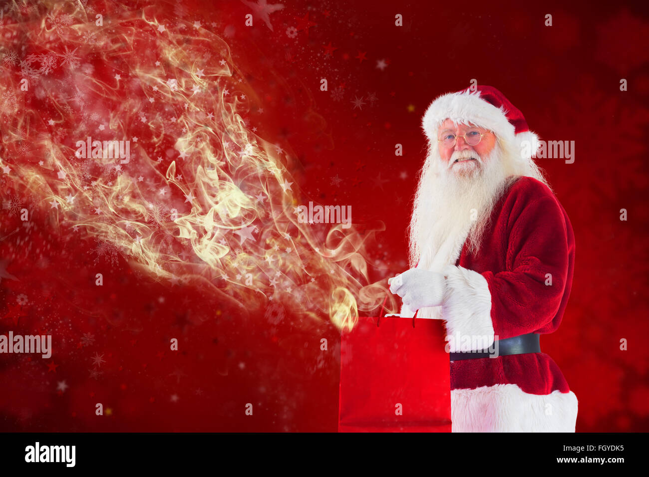 Composite image of santa carries red gift bag Stock Photo - Alamy