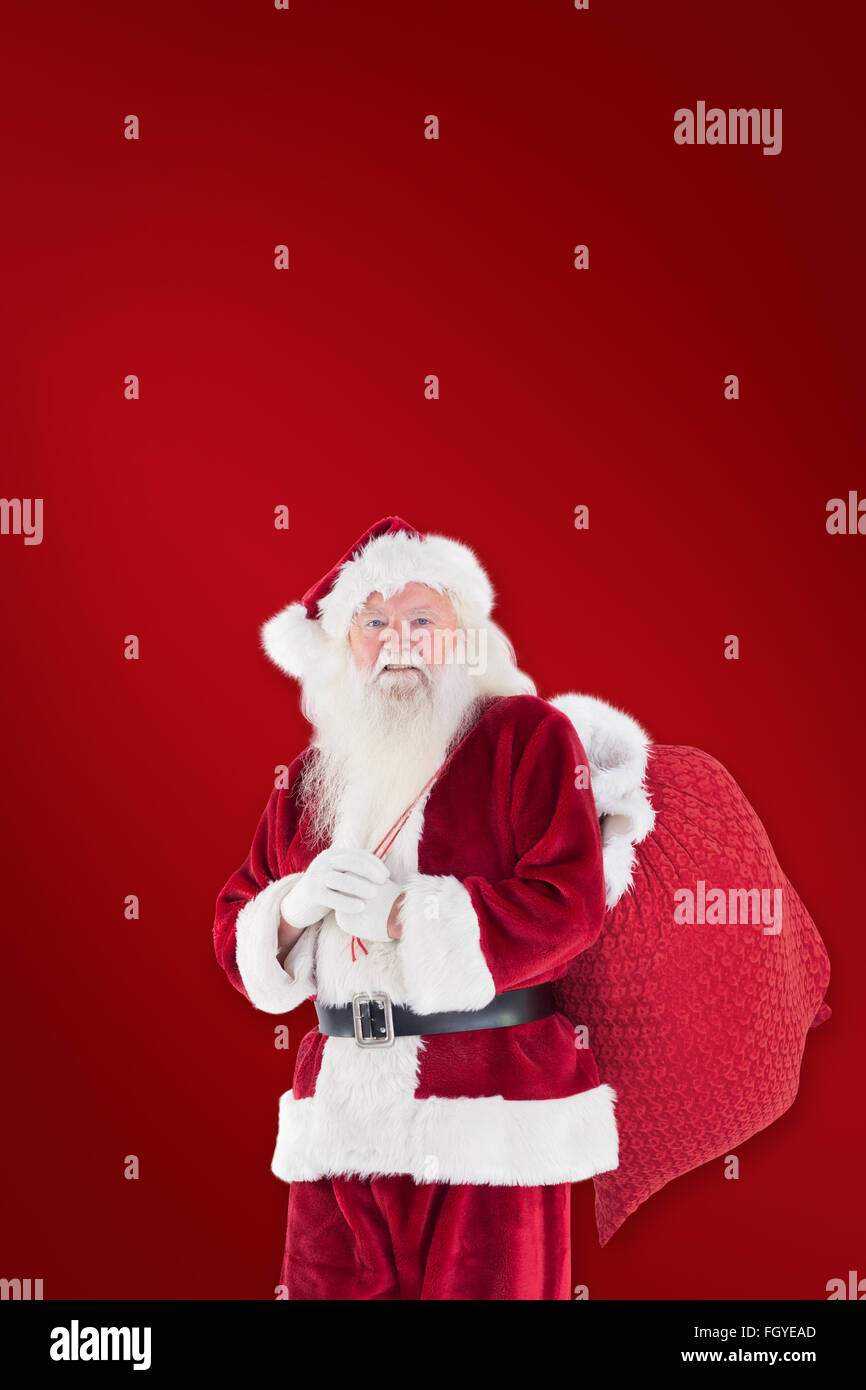 Composite image of santa carries his red bag Stock Photo - Alamy