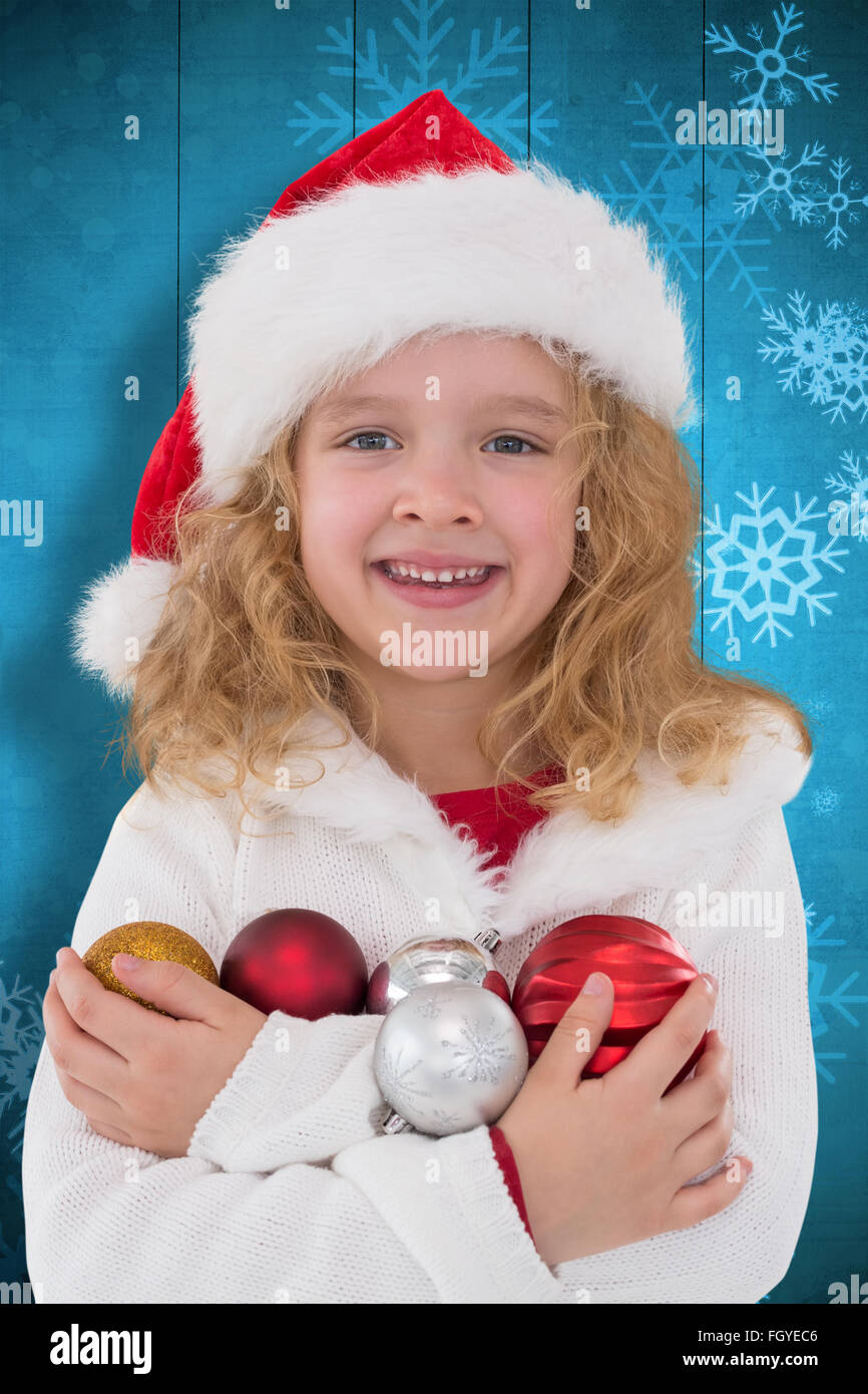 Composite image of festive little girl smiling at camera Stock Photo ...