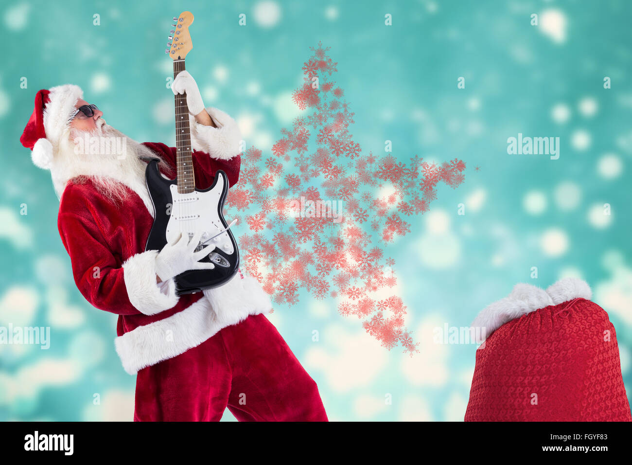 Composite image of santa playing electric guitar Stock Photo