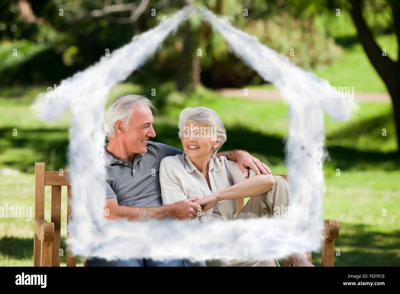 Composite image of senior couple sitting on a bench Stock Photo