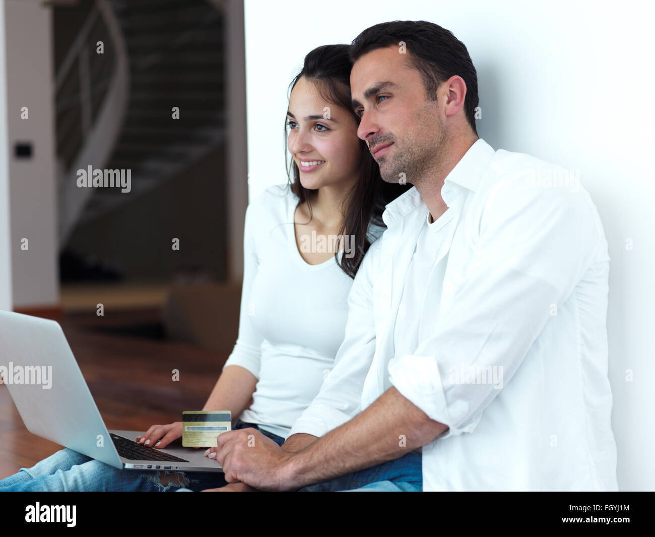 relaxed young couple working on laptop computer at home Stock Photo - Alamy