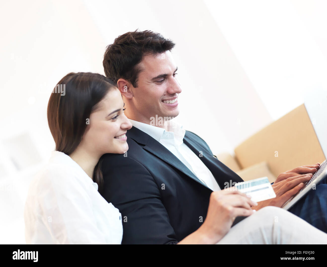 relaxed young couple working on laptop computer at home Stock Photo - Alamy