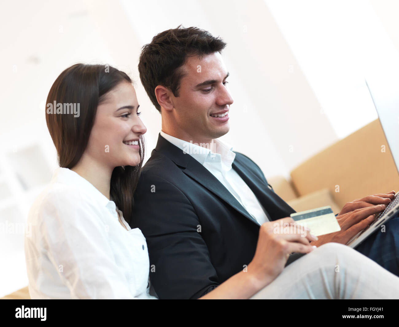 relaxed young couple working on laptop computer at home Stock Photo - Alamy