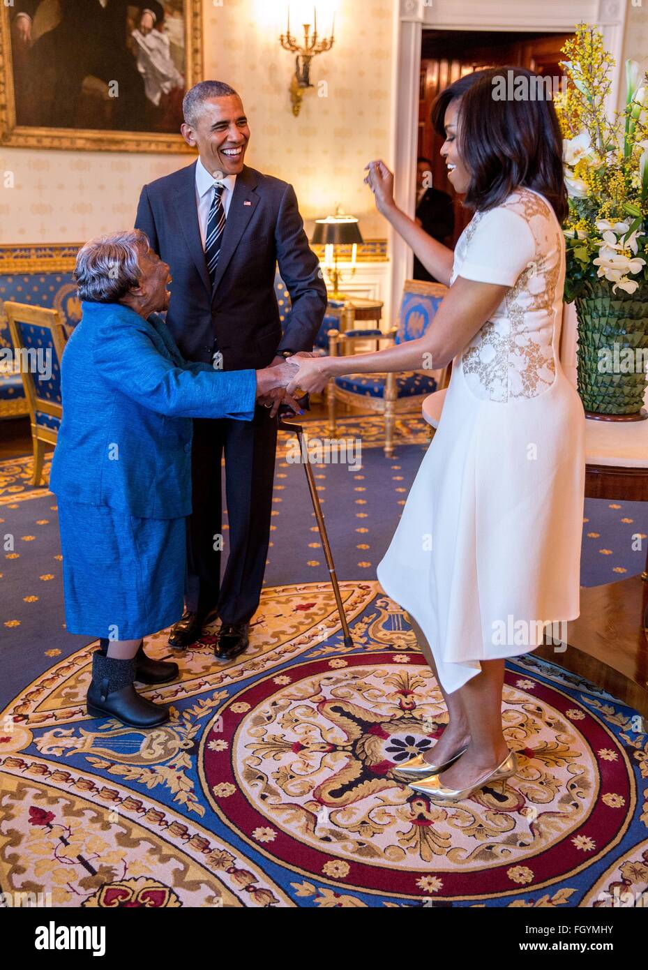 U.S. President Barack Obama watches First Lady Michelle Obama dance with 106-Year-Old Virginia McLaurin in the Blue Room of the White House prior to a reception celebrating African American History Month February 18, 2016 in Washington, DC. Stock Photo