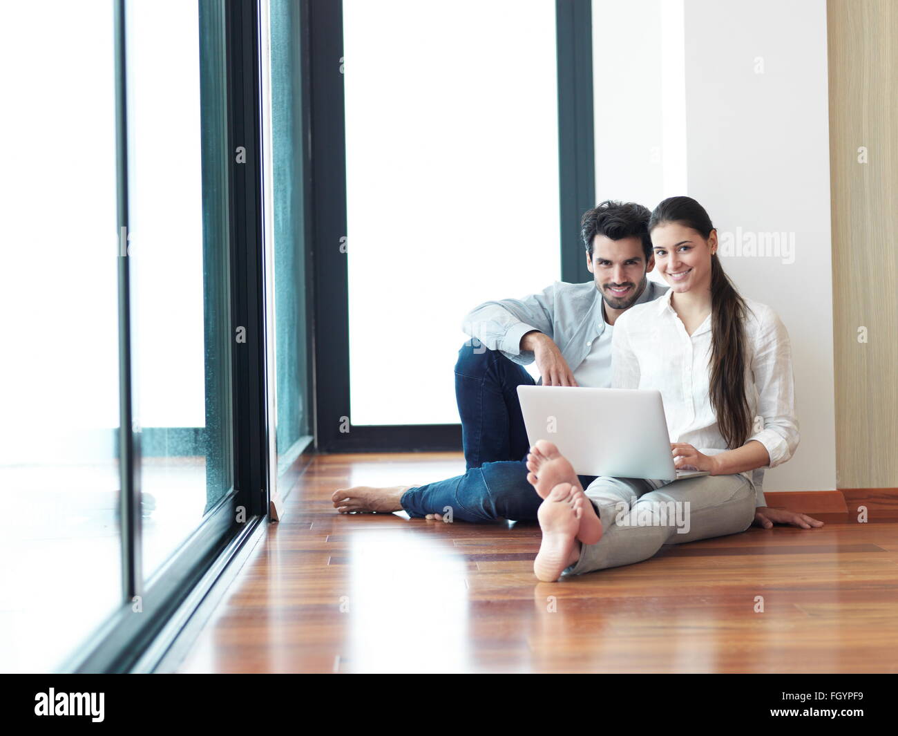 relaxed young couple working on laptop computer at home Stock Photo - Alamy