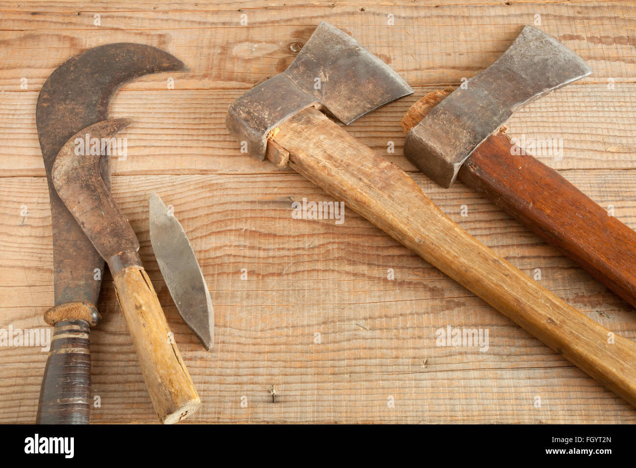 Two dated and used cleavers and billhooks on wooden background Stock Photo