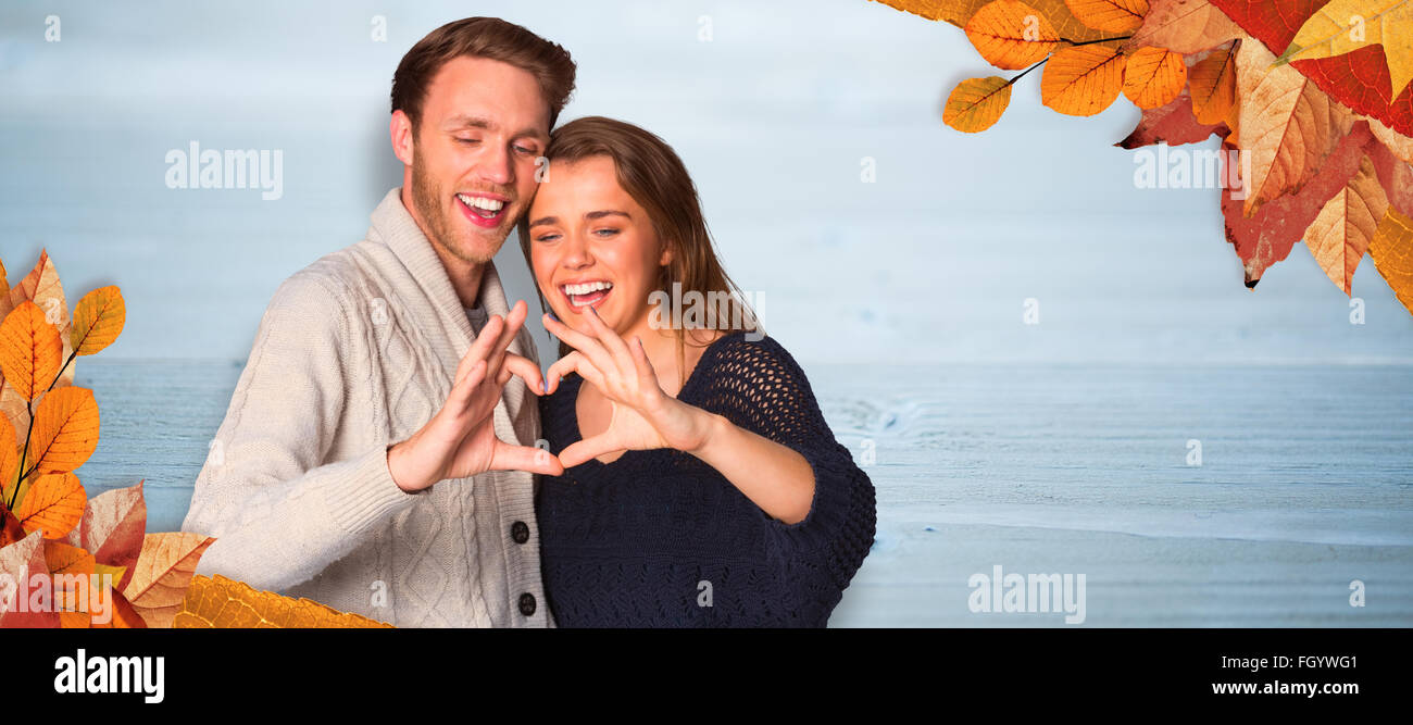 Composite image of happy couple forming heart with hands Stock Photo ...