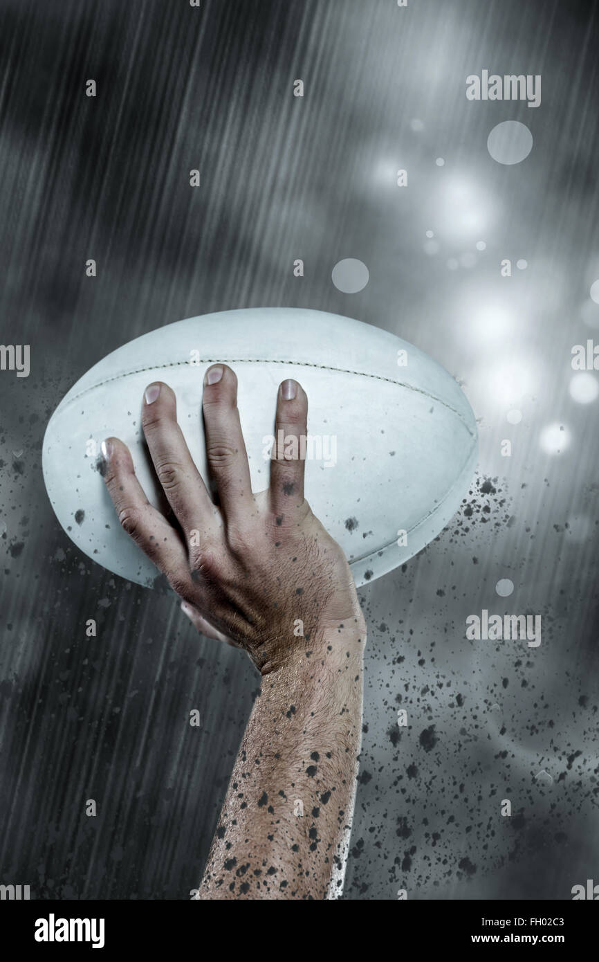 Composite image of cropped image of sports player holding ball Stock Photo
