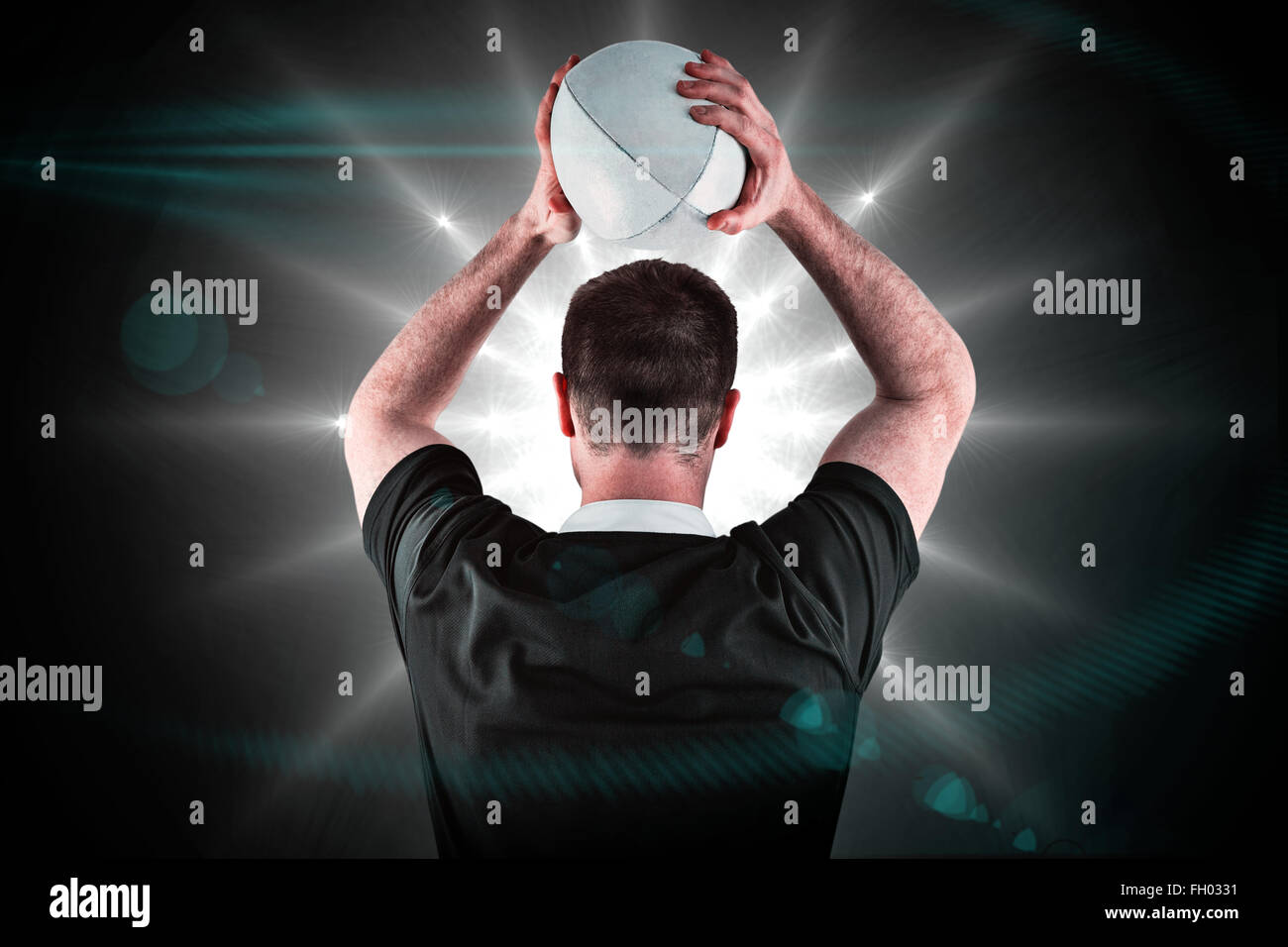 Composite image of rugby player about to throw a rugby ball Stock Photo