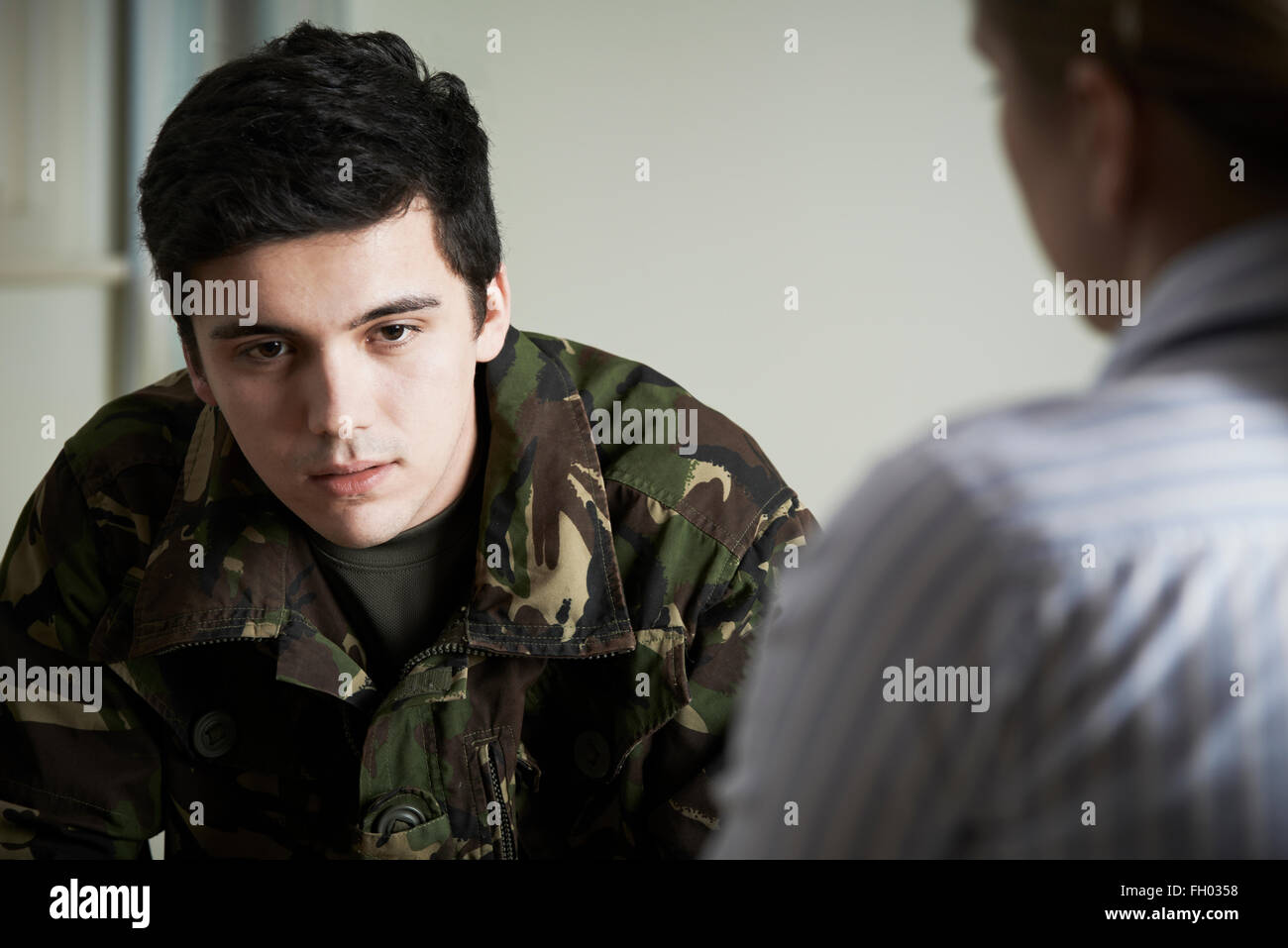 Soldier Suffering With Stress Talking To Counselor Stock Photo