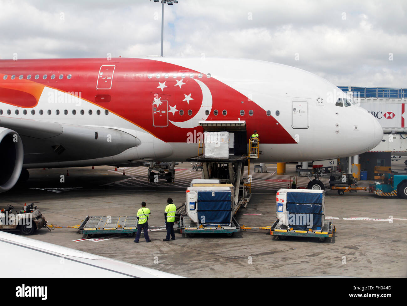 Loading baggage on Singapore Airline. Stock Photo