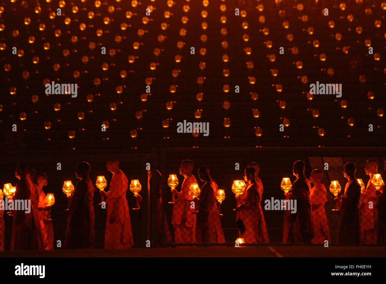 Pathum Thani, Thailand. 22nd Feb, 2016. Thai Buddhist monks gather and pray during Makha Bucha Day ceremonies at Wat Phra Dhammakaya Temple in Pathum Thani Province, Thailand, on Feb. 22, 2016. As one of Thailand's most important Buddhist festivals, Makha Bucha is observed every full moon night of the third month in the Thai lunar calendar. On the Makha Bucha day, people flock to temples and venerate Buddhas as well as pray for blessedness. Credit:  Rachen Sageamsak/Xinhua/Alamy Live News Stock Photo