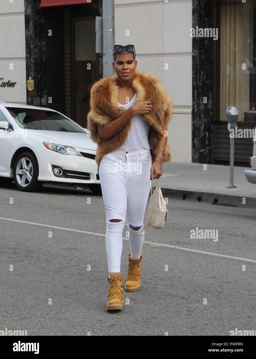 EJ Johnson sports a fur coat, Chanel handbag and a full face of makeup