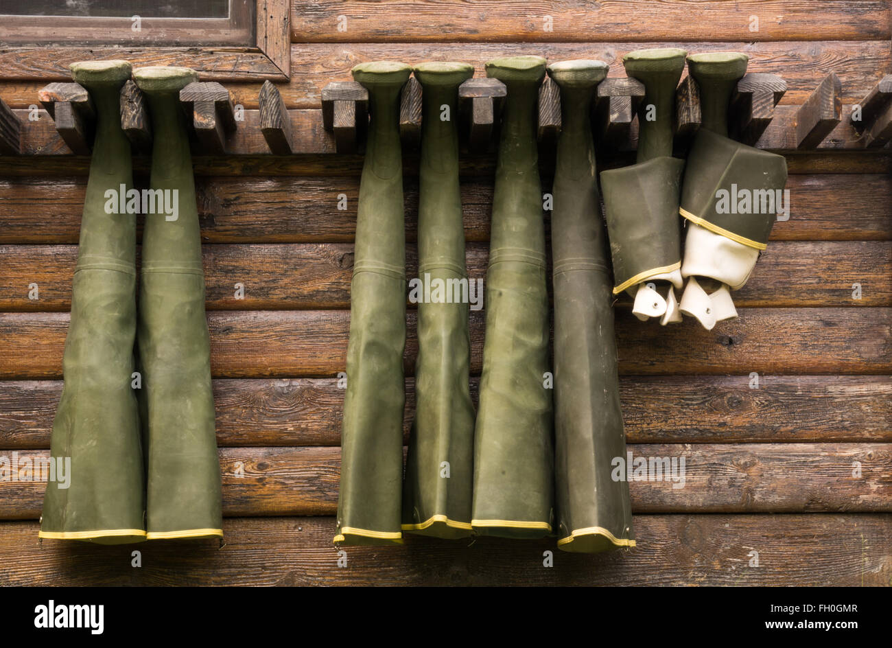 Hip waders hanging up to dry on outside of cabin wall Stock Photo Alamy