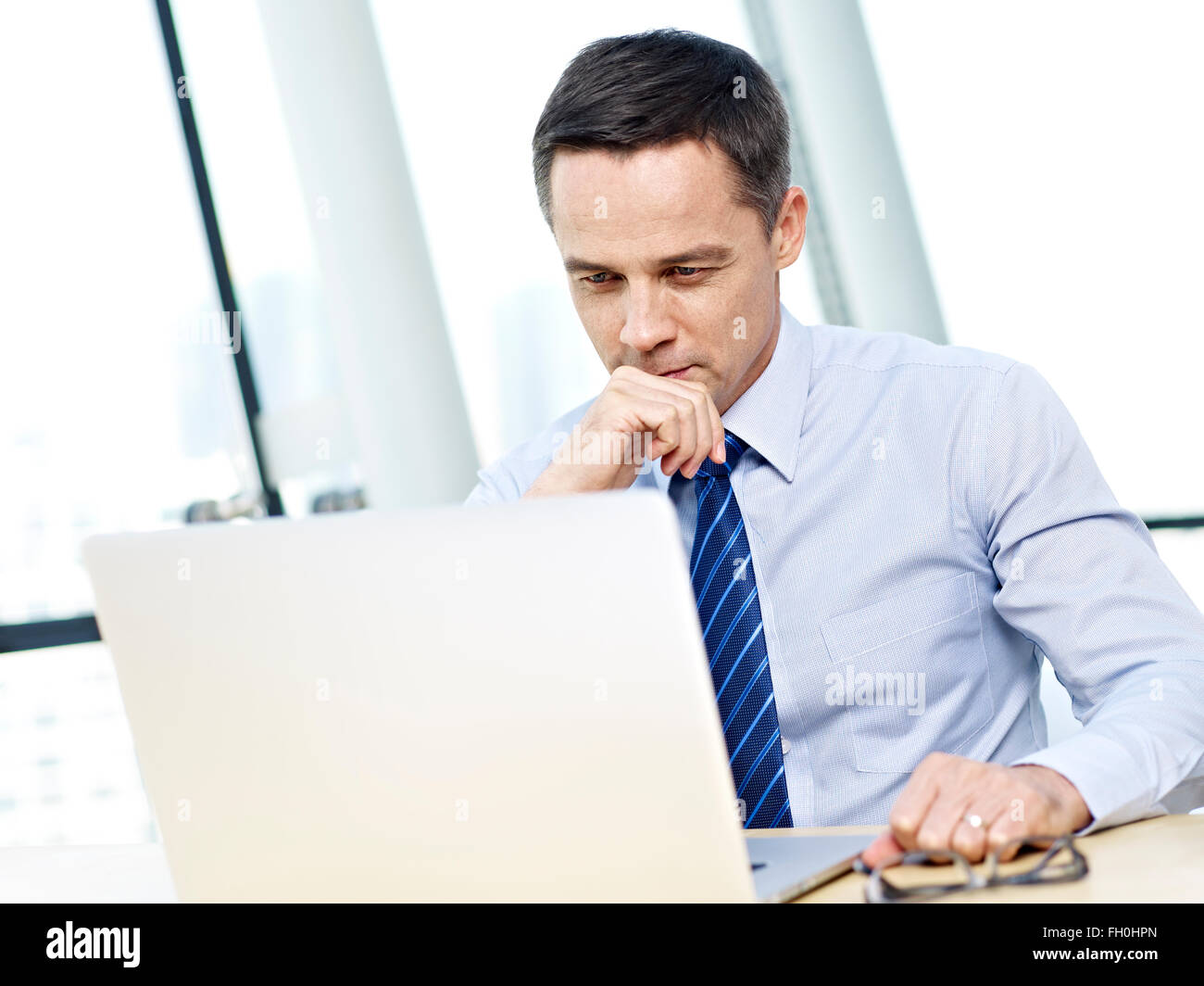 corporate person working in office on laptop computer Stock Photo