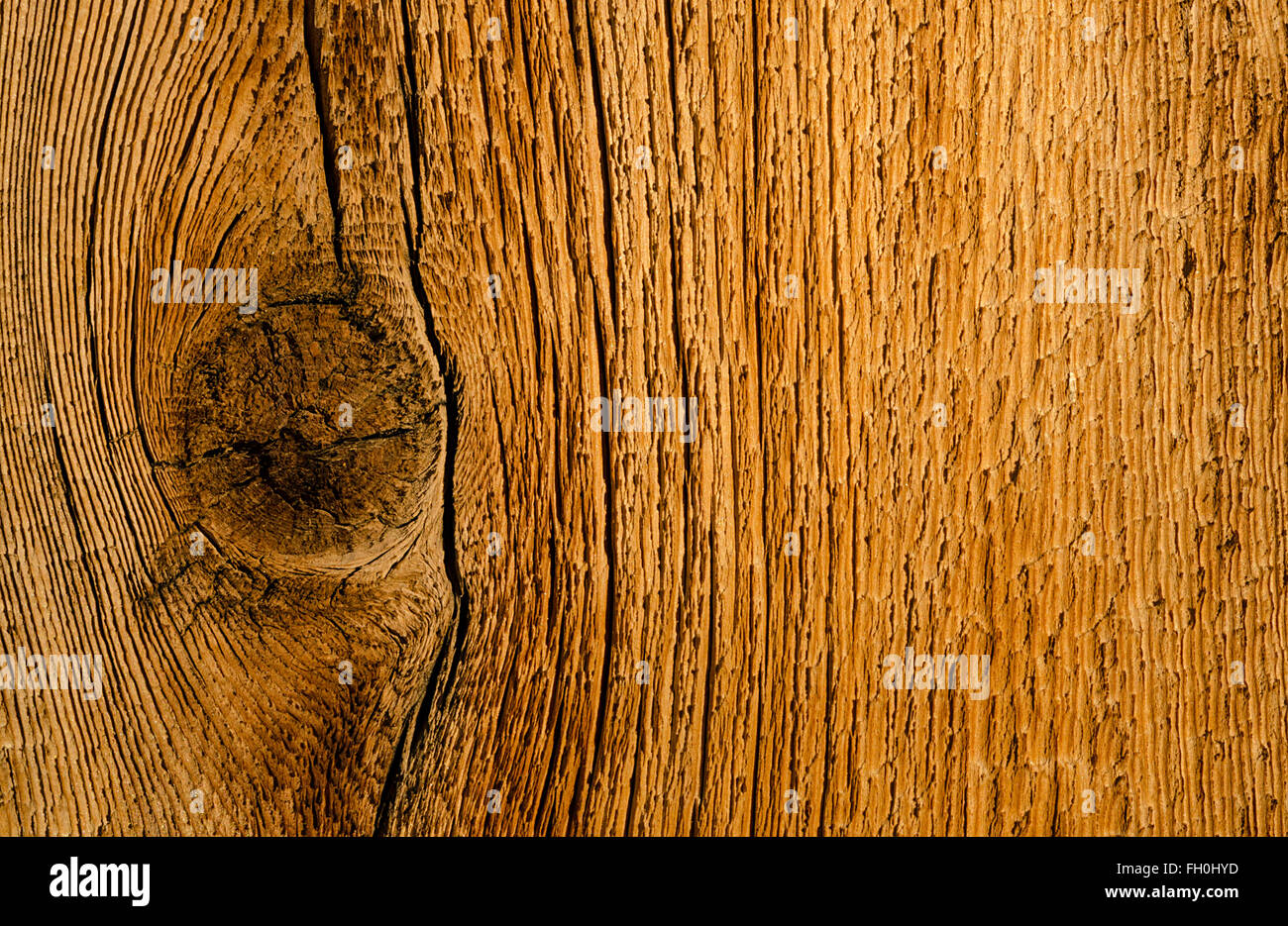 Old weathered wood plank with coarse grain pattern and knot Stock Photo
