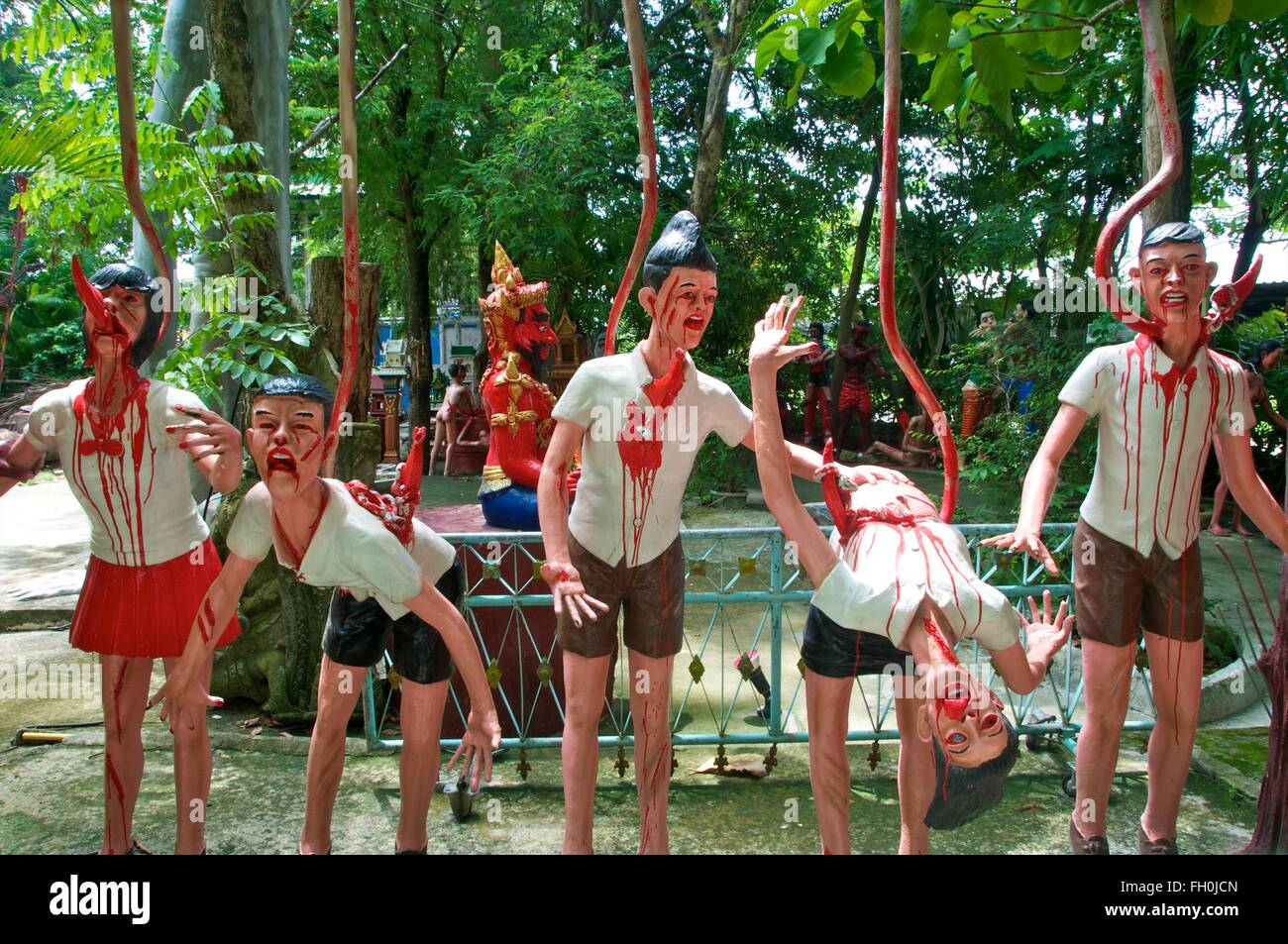 Sculpture of schoolchildren impaled on giant hooks in Buddhist Garden of Hell, Wat Mae Kaet Noi, near Chiang Mai, Thailand. Stock Photo