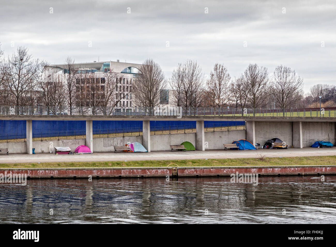 Berlin German Federal Chancellery building, River Spree and tents of homeless people in Winter Stock Photo