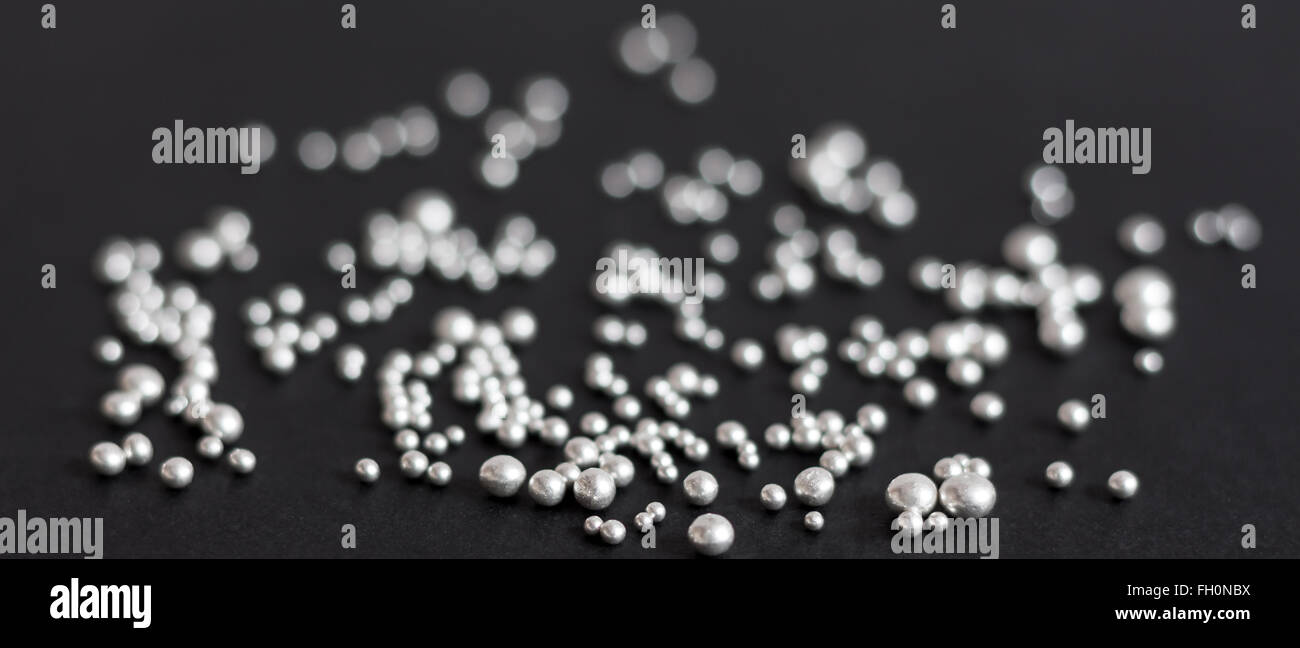 Pure silver granules on a dark background Stock Photo