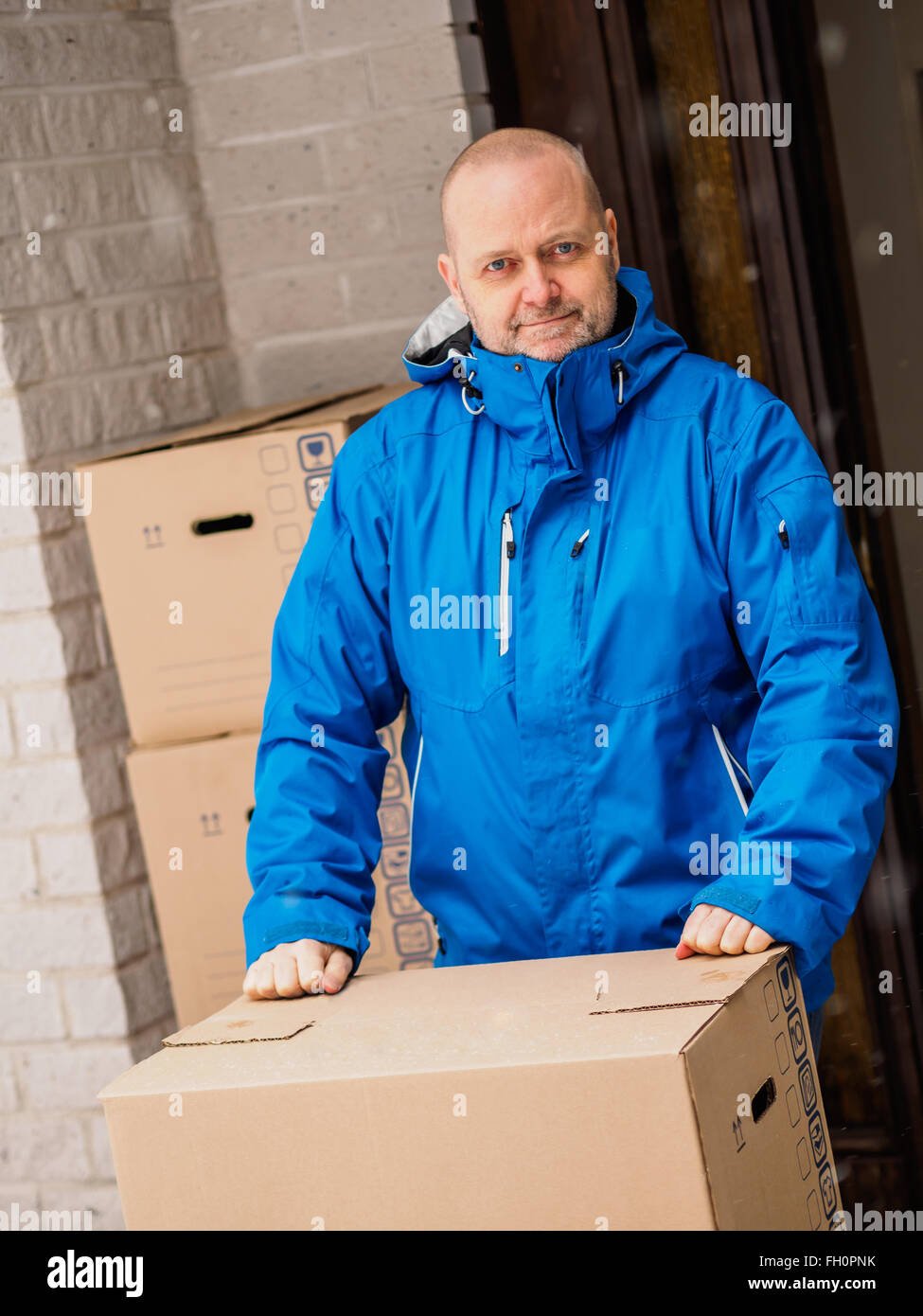People moving house, man carrying moving boxes Stock Photo Alamy