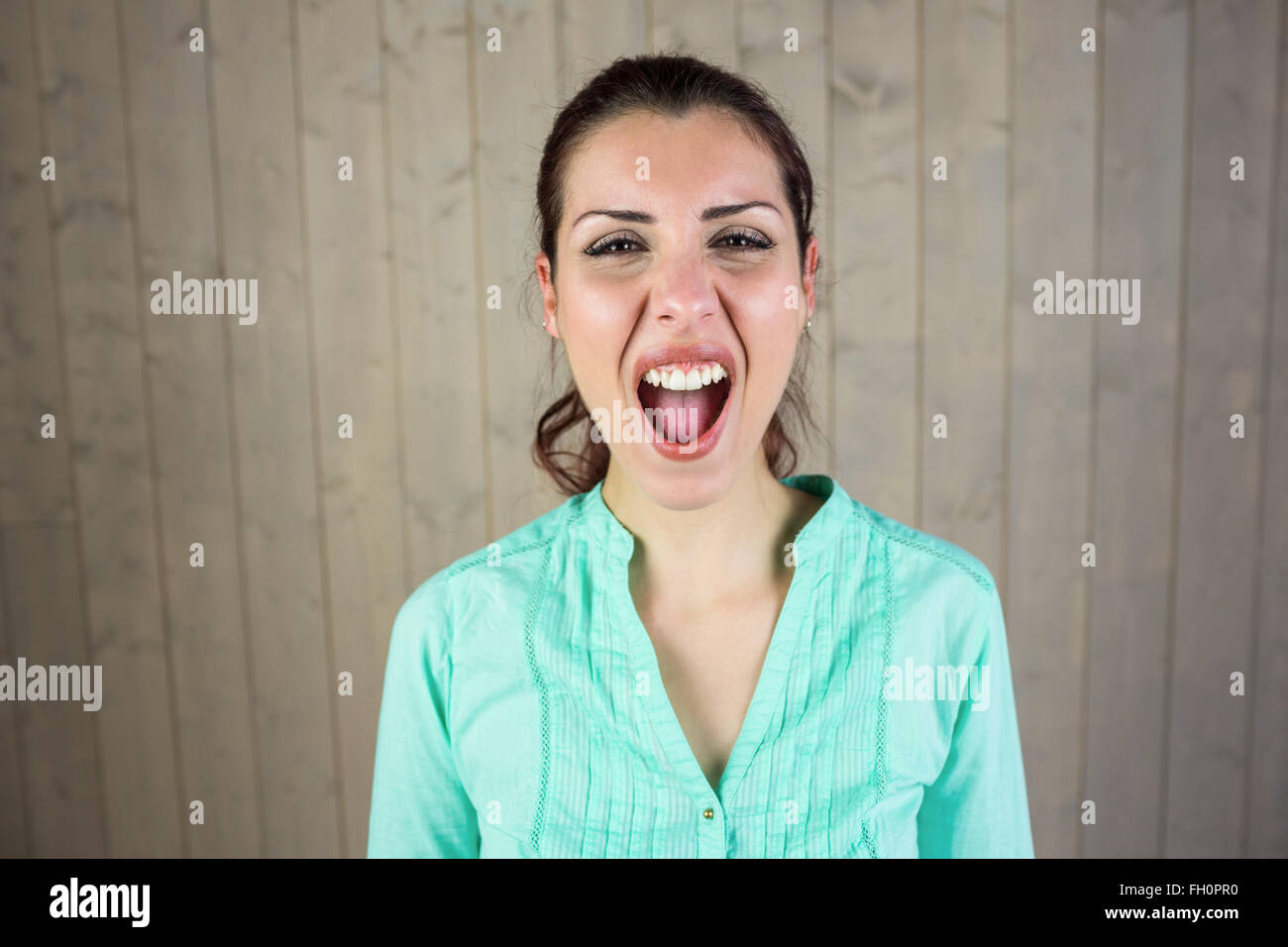 Portrait of screaming woman suffering from headache Stock Photo