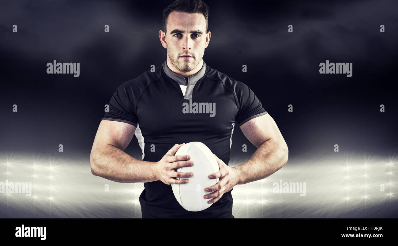 Composite image of tough rugby player looking at camera Stock Photo - Alamy