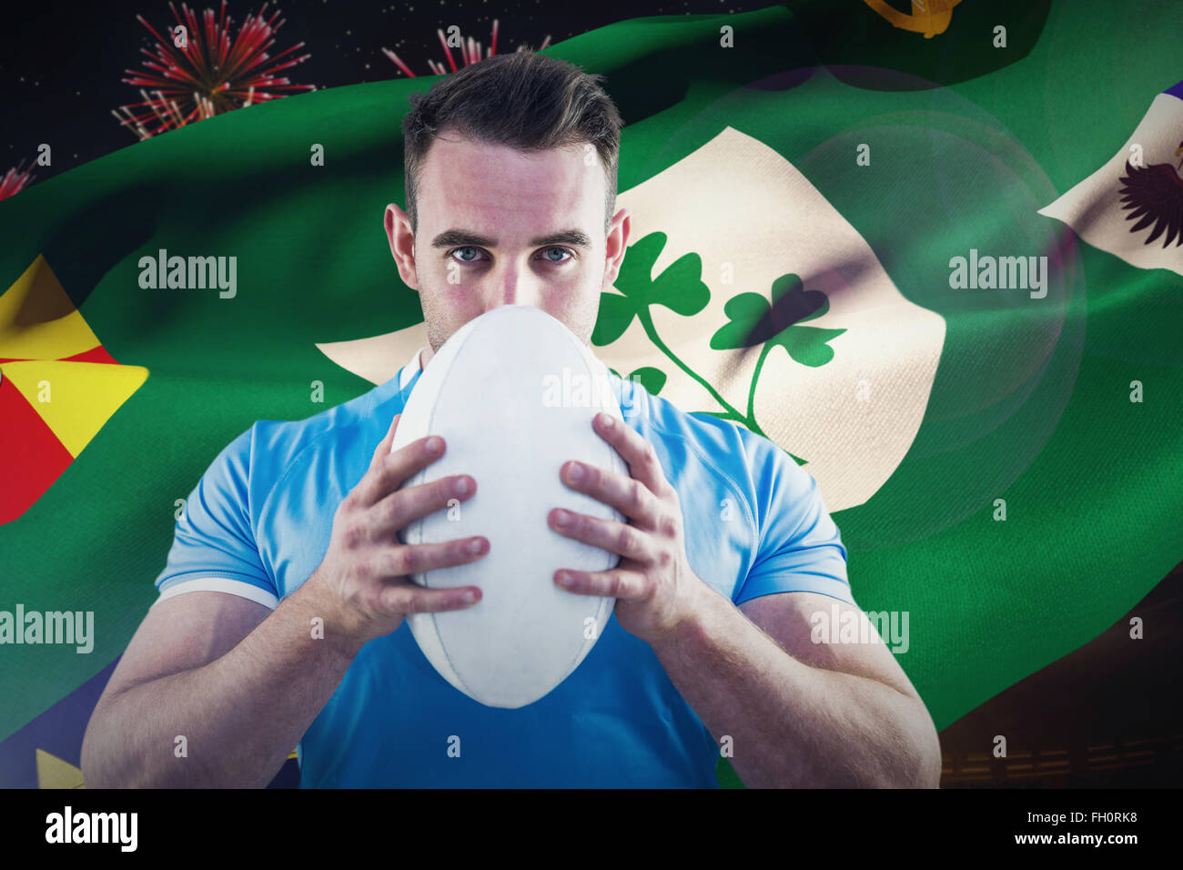 Composite image of rugby player looking at camera with ball Stock Photo