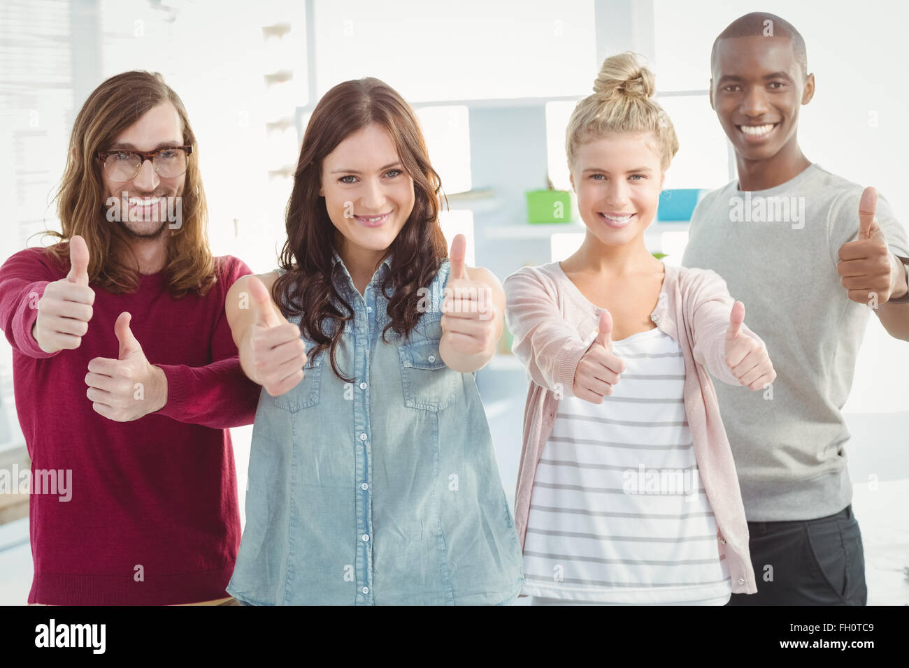 Portrait of happy business team with thumbs up Stock Photo - Alamy