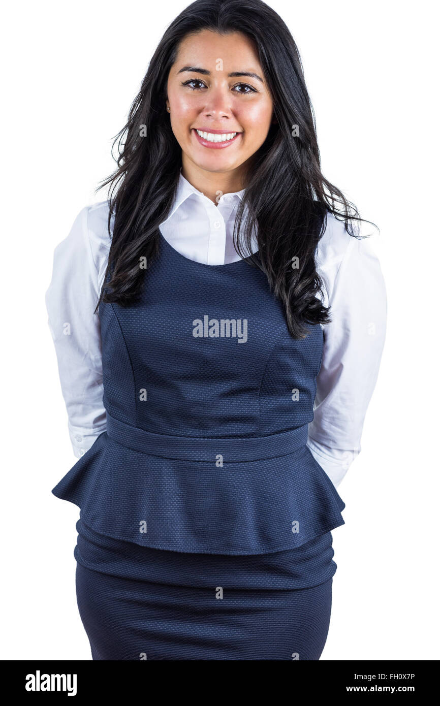 Smiling woman with hands behind her back Stock Photo - Alamy