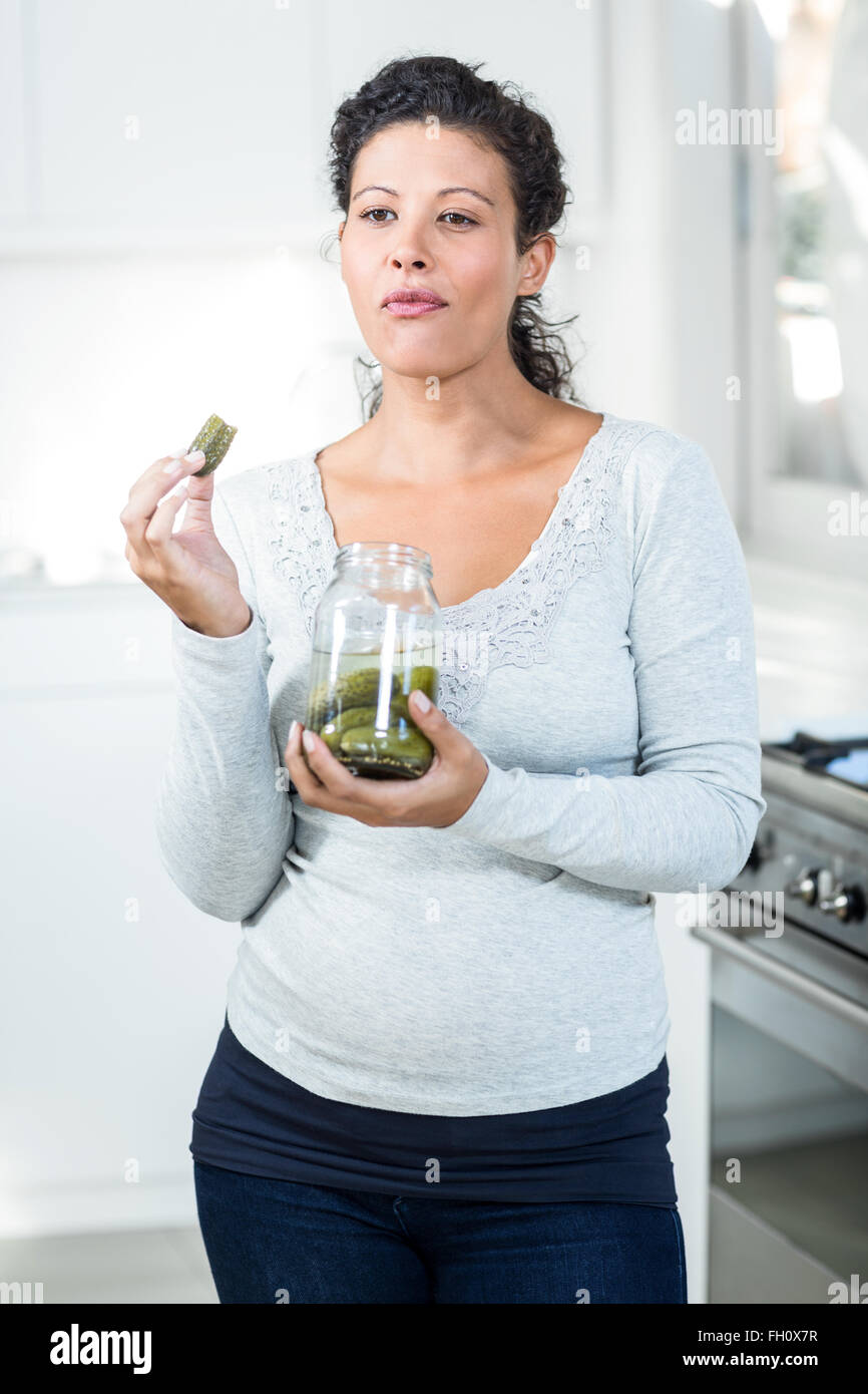 Attractive pregnant woman eating a pickle Stock Photo Alamy
