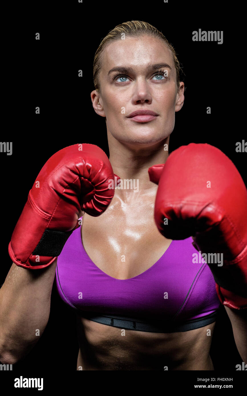 Confident female boxer with gloves Stock Photo - Alamy