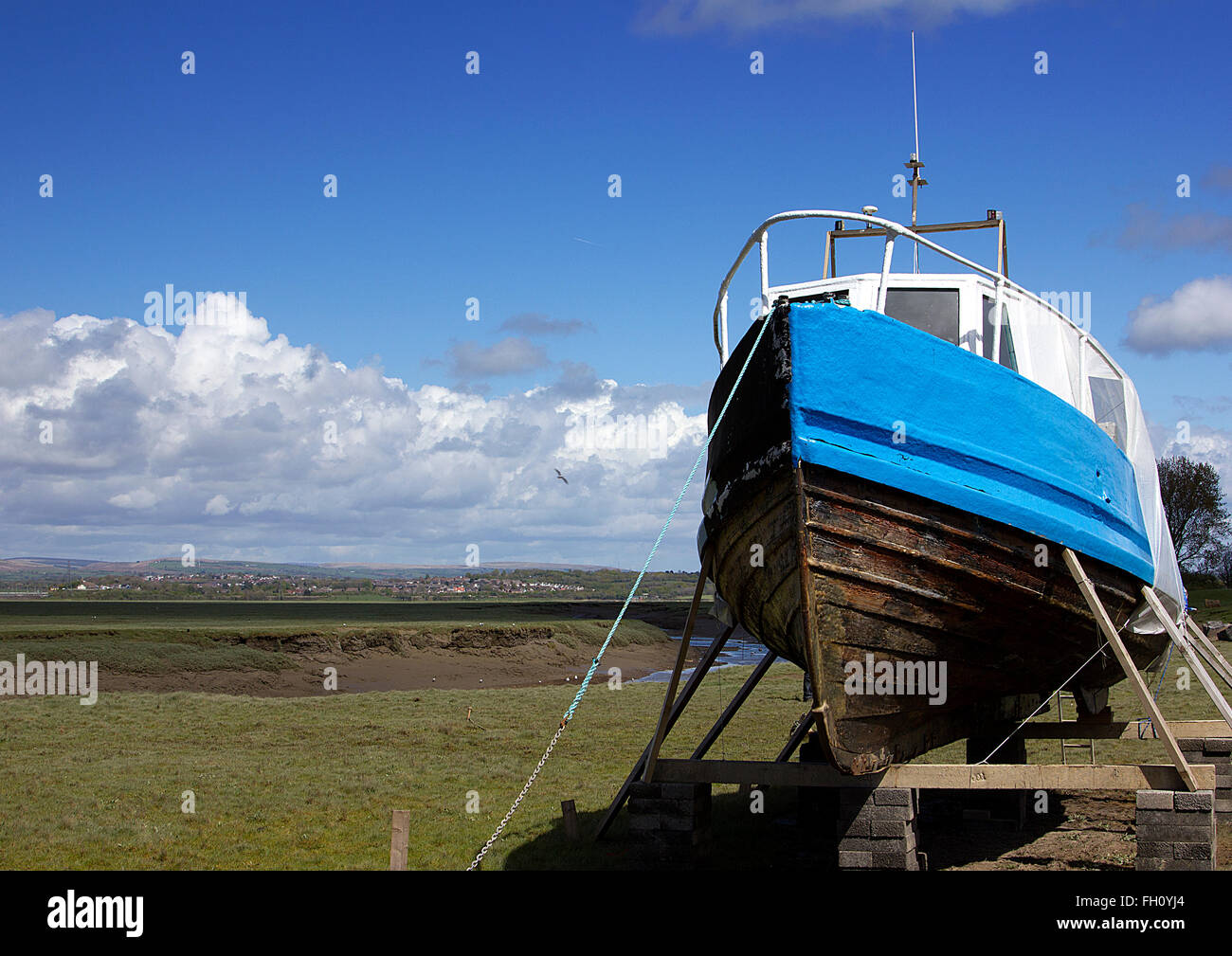 Fishing boat under repair on the Loughor Estuary, Penclawdd, north Gower, Swansea, South Wales, UK Stock Photo