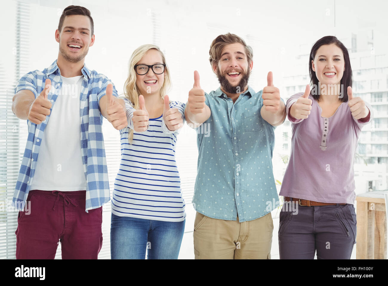 Portrait of smiling business people with thumbs up Stock Photo - Alamy