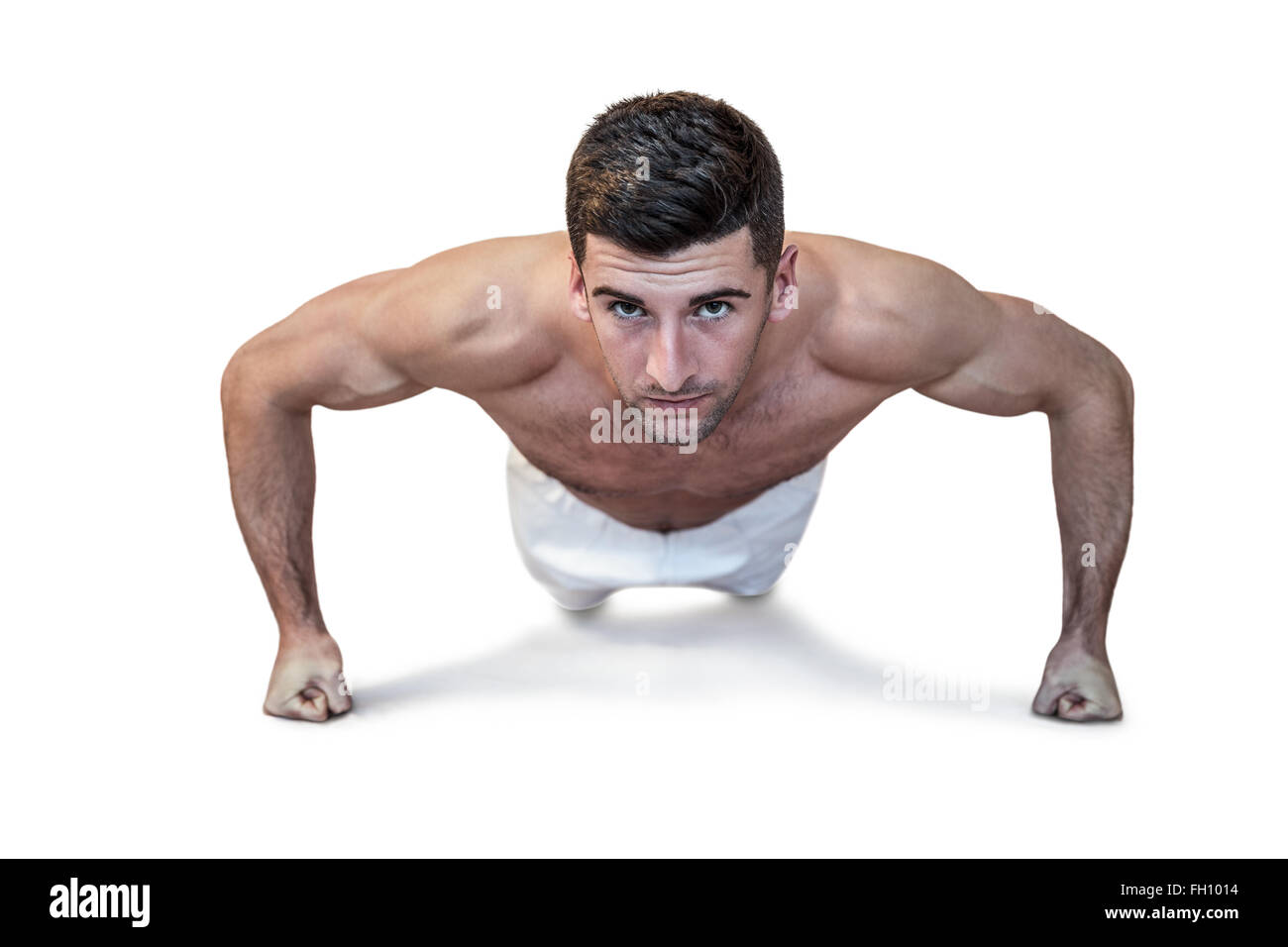Man doing push up with clenched fist Stock Photo