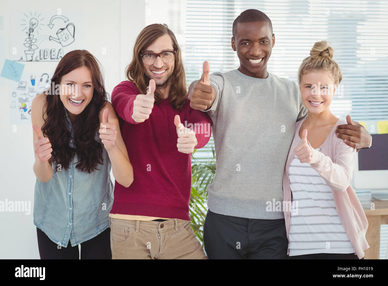Portrait of smiling business team with thumbs up Stock Photo - Alamy